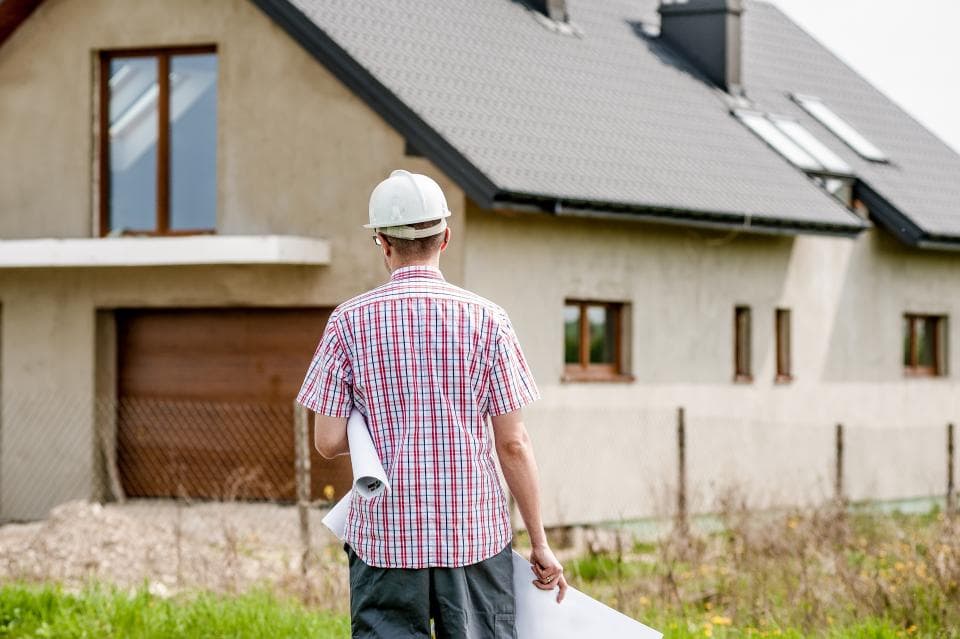Contractor reviewing a written painting specification with a homeowner
