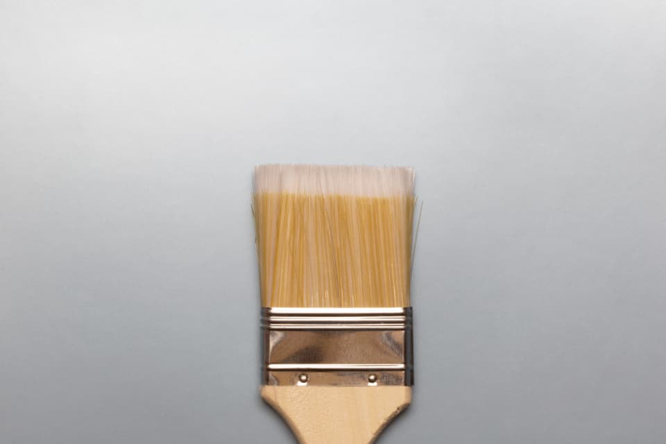 Close-up of a clean paint brush bristles on a light surface